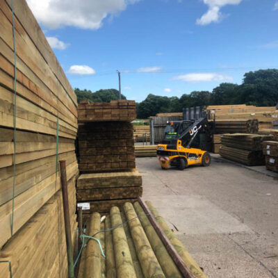 Forklift truck loading timber in Burtons timber yard